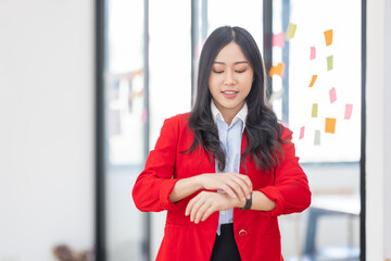 Young Serious Asian Creative team use post it notes to share idea sticky note on glass wall. Asian business people design planning and Brainstorming thinking sticky History notes concept.
