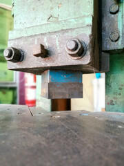 Image of metal press stamping machine in the factory.