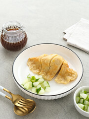 Pempek Palembang, traditional food from South Sumatra, Indonesia. This fish-based food is very popular. Served with cuko sauce and cucumber slices.
