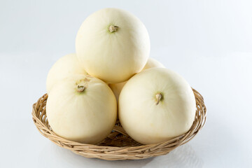 Honeydew Melons, Honey Melons, or Cantaloupe in Rattan Basket at shop and supermarket.