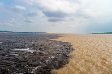 nature waterscape of amazon and rio negro rivers, brazil. photo of nature waterscape meeting waters.