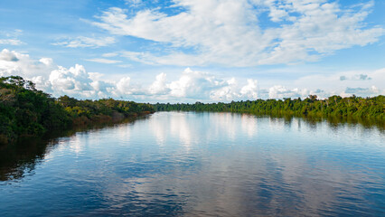 Fototapeta na wymiar The Nanay River, one of the most important freshwater channels in the Peruvian jungle surrounded by green nature, and is part of the Allpahuayo Mishana Reserve