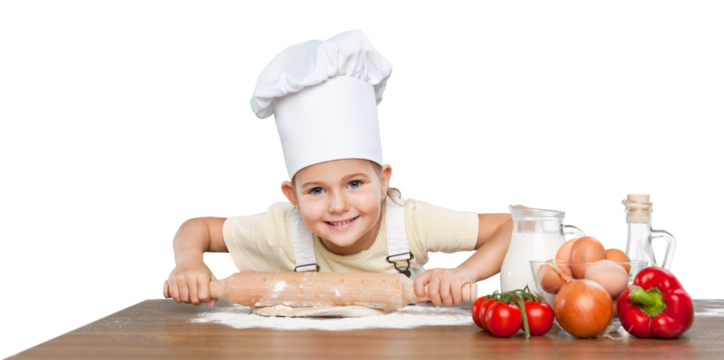 Happy little chef smeary with flour stretching the dough