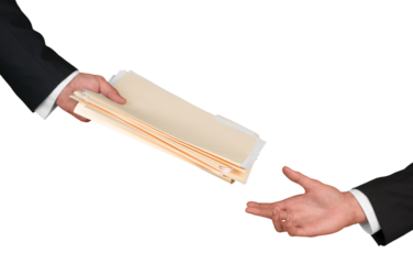 Closeup of Businesspeople Handing File Folders