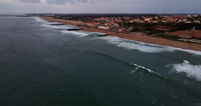 Aerial View of Anglet Beach Plage de la Chambre d'Amour in French Basque Country with multiple jetties and waves crashing on the sandy beaches