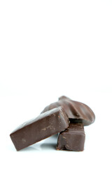 Three chocolate candies bird milk with soft filling. Delicious glazed sweets filled with whipped milk Chocolate candy on a white background, bird's milk Marshmallow in chocolate