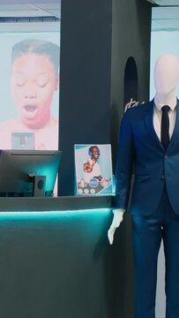 Vertical video: Multiple collections of modern clothes in retail shop boutique, casual and formal wear in shopping mall. Empty clothing shop with fashionable brands on hangers, small business.
