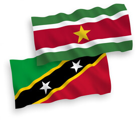 Flags of Federation of Saint Christopher and Nevis and Republic of Suriname on a white background