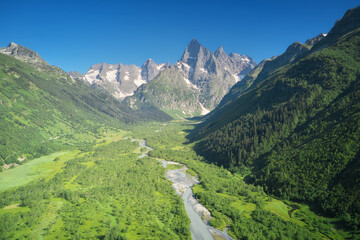 Fototapeta na wymiar Spring river in mountain valley.
