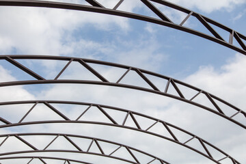 Fototapeta premium The metal frame of the canopy against the sky.