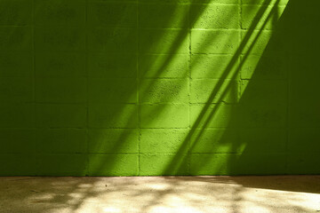 Texture, wall of weathered green color, with flashes of light and shadows.
