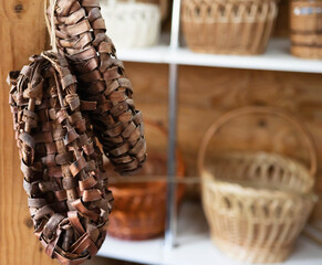 Bast shoes woven from the bark hang. Handmade, old shoes, traditional. Copy space for text