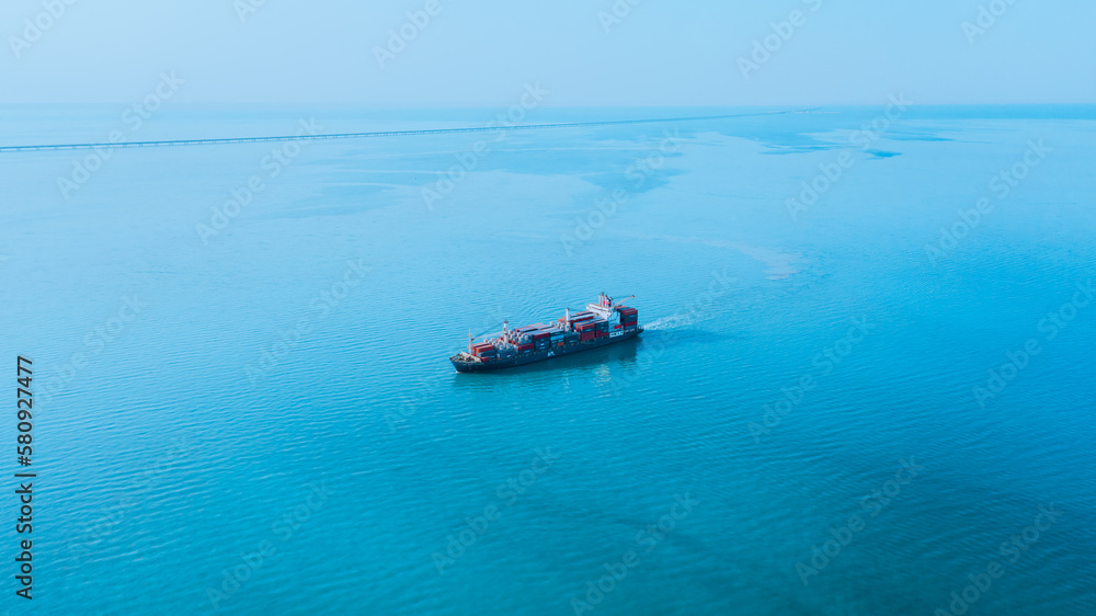 Wall mural cargo ship in the middle of the sea