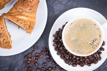 Breakfast consisting of fresh croissant with chocolate and coffee in white cup