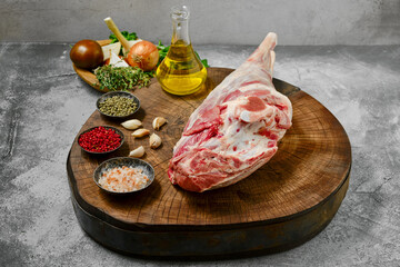 Raw whole lamb leg chump on with ingredients