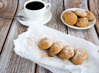 Freshly baked cookies with cinnamon, coffee. Sweet lunch. On a wooden background