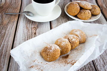Freshly baked cookies with cinnamon, coffee. Sweet lunch. On a wooden background