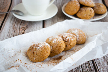 Freshly baked cookies with cinnamon, coffee. Sweet lunch. On a wooden background
