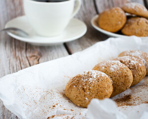 Freshly baked cookies with cinnamon, coffee. Sweet lunch. On a wooden background