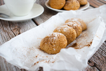 Freshly baked cookies with cinnamon, coffee. Sweet lunch. On a wooden background
