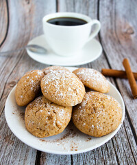 Freshly baked cookies with cinnamon, coffee. Sweet lunch. On a wooden background