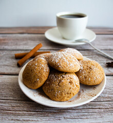 Freshly baked cookies with cinnamon, coffee. Sweet lunch. On a wooden background