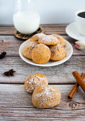 Freshly baked cookies with cinnamon, coffee. Sweet lunch. On a wooden background