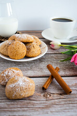 Freshly baked cookies with cinnamon, coffee. Sweet lunch. On a wooden background