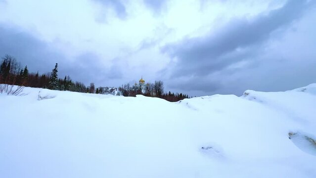 Belogorsky St. Nicholas Orthodox Missionary Monastery. Russia, Perm Krai, Belaya Gora. The temple on the hill in winter. Monastery on the background of snow. 4K