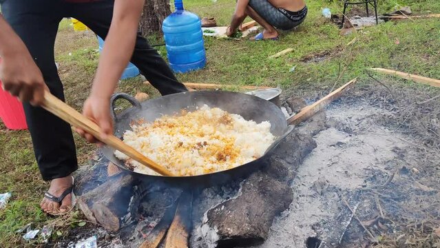 Aceh, Indonesia – March 14, 2023: Making fried rice perfunctory at tourist attractions in Aceh province, Aceh Province, Indonesia on March 14, 2023