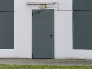 Gray metal door at the back of the building