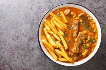 Khoresh Gheymeh yellow split peas, saffron, tomato paste, diced meat, and sun-dried lime are the main ingredients of this delicious stew closeup on a plate on the table. Horizontal top view from above