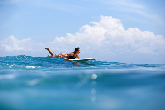 Woman surfboarding in sea