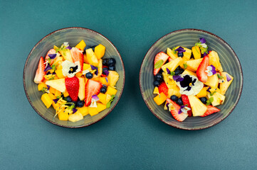 Fruit salad decorated with flowers.