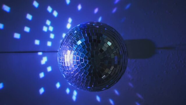 the disco ball spins and glows in different directions in blue. close-up. High-quality Full HD video recording