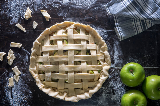 Green apple pie on wooden table
