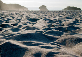 Close-up of sand at beach on sunny day