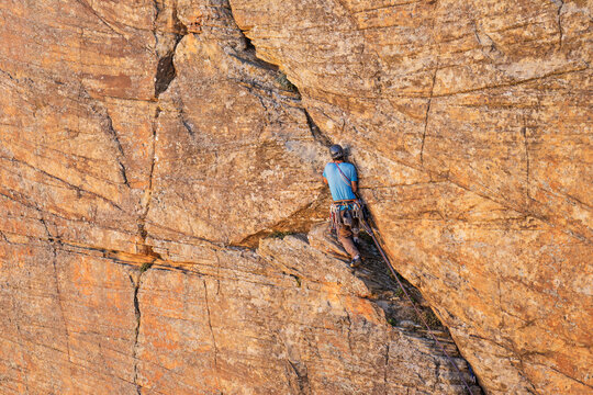 Rear view of man climbing mountain