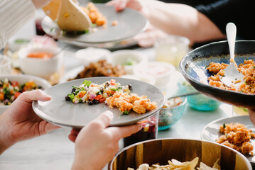 Cropped image of friends having food at dining table in party