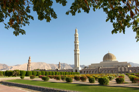 Sultan Qaboos Grand Mosque on sunny day against clear blue sky