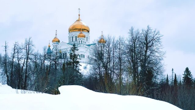 Belogorsky St. Nicholas Orthodox Missionary Monastery. Russia, Perm Krai, Belaya Gora. The temple on the hill in winter. Monastery on the background of snow. 4K