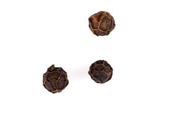 Black pepper seeds on white