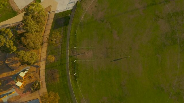 People kicking Australian Football back and forth without much luck hitting their target.