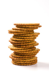 Heap of round thin crispy biscuits isolated on white background.