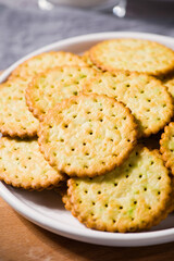 round thin crispy biscuits or crackers on wooden table