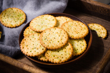 round thin crispy biscuits or crackers on wooden table
