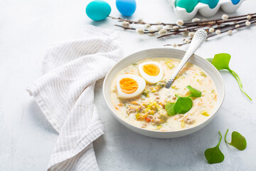 Traditional Polish sour soup Zurek in ceramic bowl  for Easter