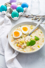 Traditional Polish sour soup Zurek in ceramic bowl  for Easter