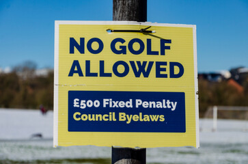 No Golf allowed sign on the edge of a public football pitch