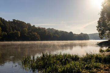 Fototapeta na wymiar Fog-covered river in the autumn season